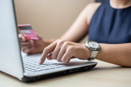 Businesswoman holding credit card  for online shopping while making orders via the Internet. business, technology, ecommerce and online payment conceptの写真素材