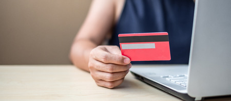 Businesswoman holding credit card  for online shopping while making orders via the Internet. business, technology, ecommerce and online payment conceptの写真素材