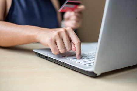 Businesswoman holding credit card  for online shopping while making orders via the Internet. business, technology, ecommerce and online payment conceptの写真素材