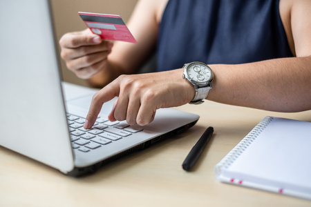 Businesswoman holding credit card and using smartphone for online shopping while making orders via the Internet. business, technology, ecommerce and online payment conceptの写真素材
