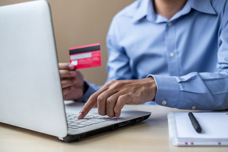 Businessman holding credit card  for online shopping while making orders via the Internet. business, technology, ecommerce and online payment conceptの写真素材