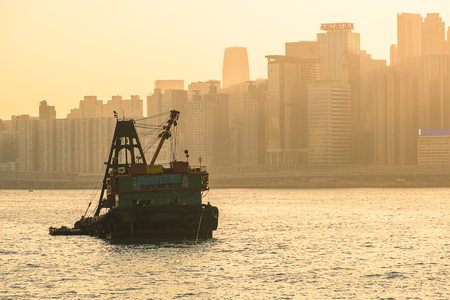nternational Container Cargo ship in the ocean with Hong Kong cityscape background in the morning sunrise and twilight sky, transportation and logisticの写真素材