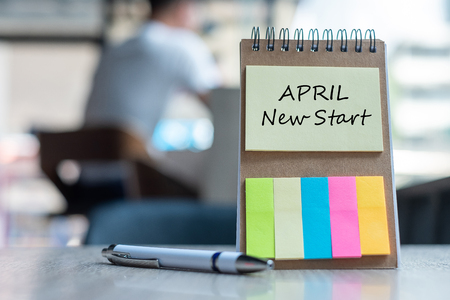 Aprill New Start  with note paper reminder template with pen on wooden table. Copy space for your textの写真素材