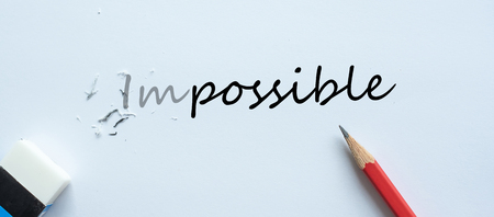 erasing IMPOSSIBLE text change to POSSIBLE. challenge, positive thinking and success conceptの写真素材