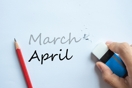 Businessman erasing March text change to April. month and Season change conceptの写真素材