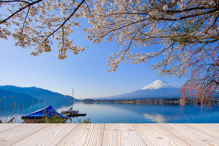 Empty wood table with Fuji mountain and beautiful pink cherry blossom flower background in spring season, Mock up for your product display or montageの写真素材