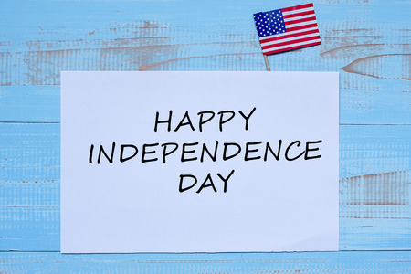 Happy Independence day with flag of the United States of America on blue wooden background.の写真素材