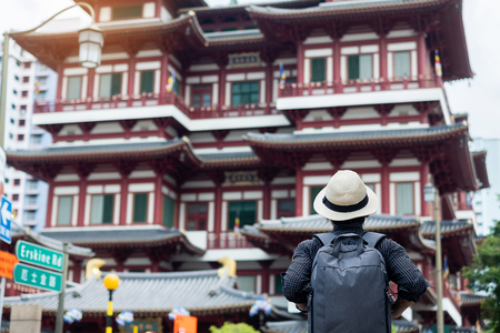 man hipster traveling with backpack and hat, Solo traveler looking to Buddha Tooth Relic Templeの写真素材