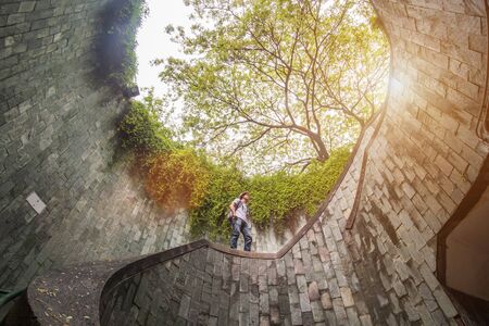 young man tourist traveling and standing on underground spiral staircase at Parkの写真素材