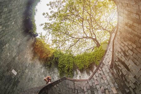 Young Woman tourist traveling and standing on underground spiral staircase at Parkの写真素材