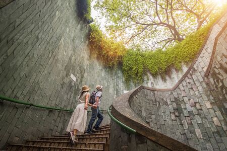 happy couple tourist traveling on underground spiral staircase at Parkの写真素材