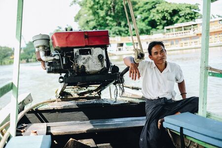 Boatman with his boat on Irrawaddy river,  for transfer tourists from Amarapura to ancient Ava (innwa). Mandalay, Myanmar, 11 August 2018のeditorial素材