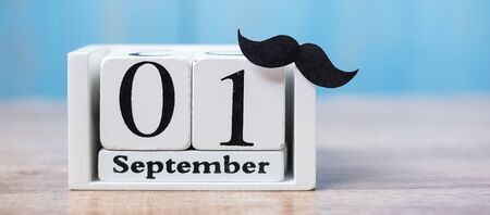 1 September Calendar and moustache on wood table background. Father, International men day, Prostate Cancer Awareness and World cancer day conceptの写真素材
