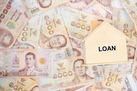 Wood house model, calculator and money, Thai baht banknote. real estate, Property investment, home...