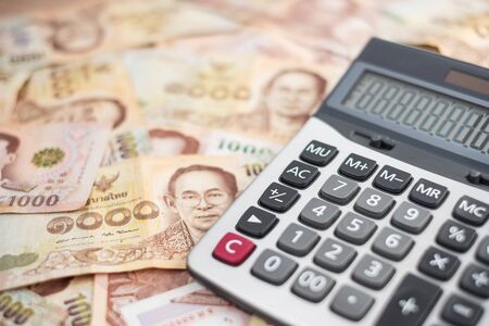 1000 Thai Baht banknote background with Calculator. business, investment, retirement planning, finance and Saving for the future conceptsの写真素材
