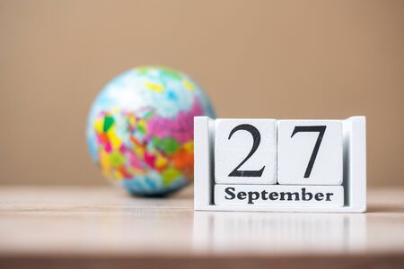 27 September of calendar wooden on table, word tourism day conceptの写真素材
