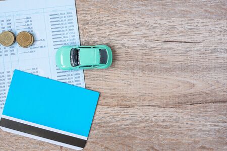 Book bank with Car on wood table background with copy space. financial, money, refinance, Car for cash and Car insurance conceptの写真素材