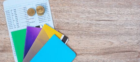 book bank and coins on wood table background with copy space. banking, business, investment, retirement planning, finance and Saving for the future conceptsの写真素材