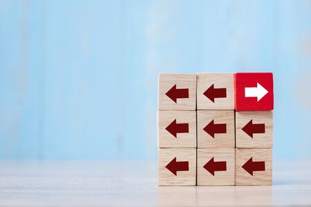 Red block with different direction of arrow on table background. Business Growth, Improvement,...