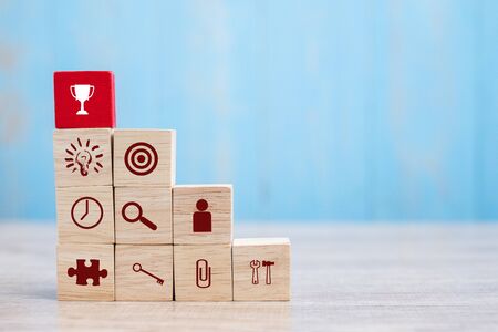 Red block with Trophy and business strategy icon on table background. Business Growth, Improvement, strategy, Successful, success, winner, cooperation and Mission complete Conceptsの写真素材
