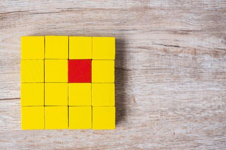 Red cube block different from crowd of yellow blocks. Unique Leader, strategy, independence, think...
