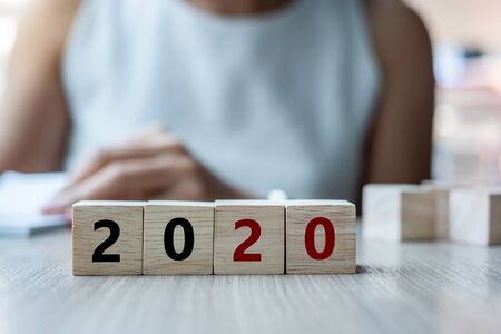 wooden cube with 2020 word on table background. Resolution, strategy, solution, goal, business, New...