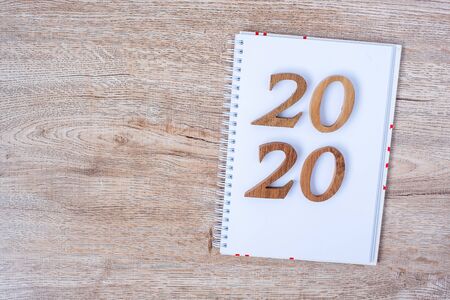 2020 Happy New years with blank notebook for text and wooden number on table and copy space. New Start, Resolution, Goals and Mission Conceptの写真素材