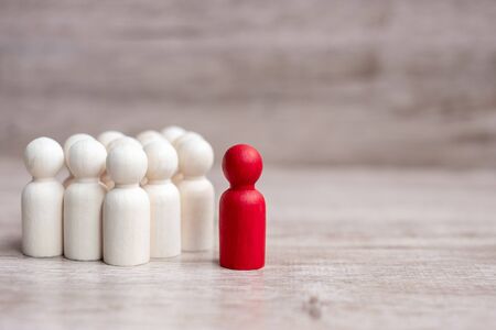 red leader businessman with crowd of wooden men. leadership, business, team, teamwork and Human resource management conceptの写真素材