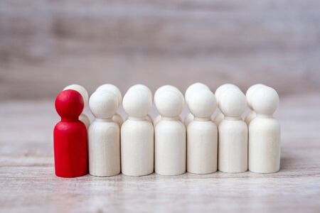 red leader businessman with crowd of wooden men. leadership, business, team, teamwork and Human resource management conceptの写真素材