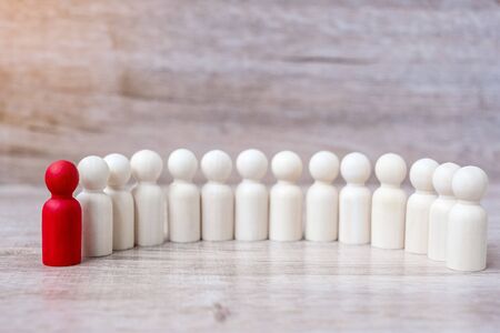 red leader businessman with crowd of wooden men. leadership, business, team, teamwork and Human resource management conceptの写真素材