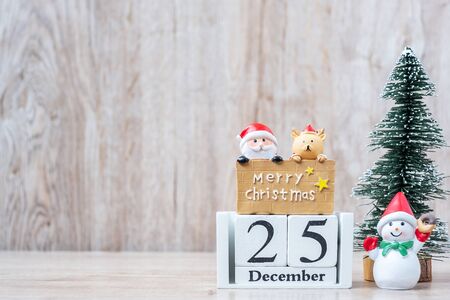 25 December calendar with Christmas decoration, snowman, Santa claus and pine tree  on wooden table background, preparation for holiday, Happy New Year and Xmas Conceptの写真素材