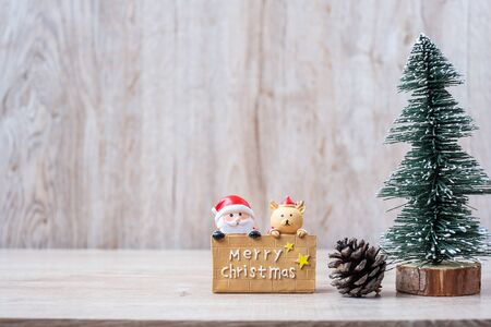 Christmas decoration, snowman, Santa claus and pine tree  on wooden table background, preparation for holiday, Happy New Year and Xmas Conceptの写真素材