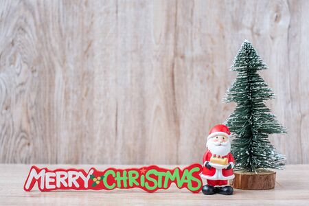 Christmas decoration,  Santa claus and pine tree  on wooden table background, preparation for holiday, Happy New Year and Xmas Conceptの写真素材