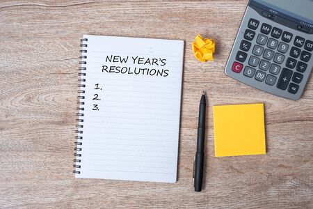 2020 NEW YEAR RESOLUTION word on note with pen and crumbled paper on wooden table background. NEW START, Strategy and Goal conceptの写真素材
