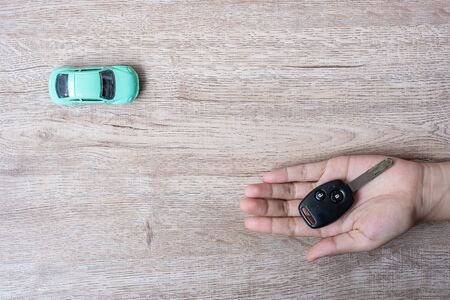 Man hands holding Key of car. Banking, Insurance, financial, Car for Cash and savings conceptsの写真素材