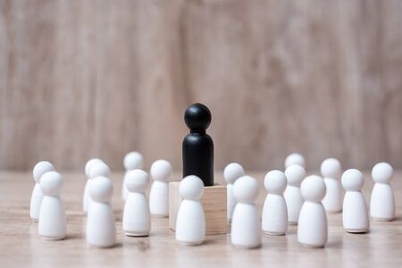 black leader businessman with crowd of wooden employees. leadership, business, team, teamwork and Human resource management conceptの写真素材