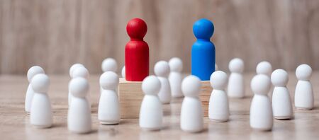 Red and Blue businessman leader  with crowd of wooden employee. leadership, business, team, teamwork and fighting conceptの写真素材