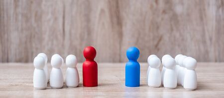 Red and Blue businessman leader  with crowd of wooden employee. leadership, business, team, teamwork and fighting conceptの写真素材