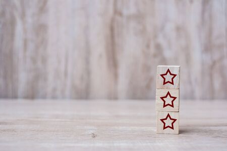 wooden blocks with the three star symbol. Customer reviews, feedback, rating, ranking and service concept.の写真素材