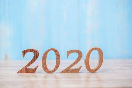 2020 wooden number on blue table background with copy space for text. Business Goals, Mission, Resolution, New Year and New start conceptの写真素材