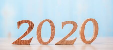 2020 wooden number on blue table background with copy space for text. Business Goals, Mission, Resolution, New Year and New start conceptの写真素材