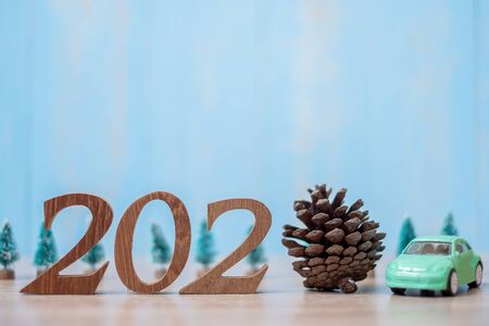 2020 Happy New Year with Car on wood table background with copy space. financial, money, refinance, Car for cash and Car insurance conceptの写真素材