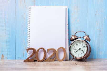 2020 Happy New Year  with blank notebook, retro alarm clock and wooden number. New Start, Resolution, Goals, Plan, Action and Mission Conceptの写真素材