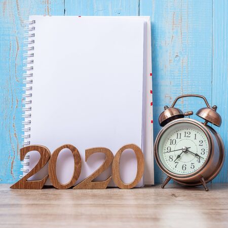 2020 Happy New Year  with blank notebook, retro alarm clock and wooden number. New Start, Resolution, Goals, Plan, Action and Mission Conceptの写真素材