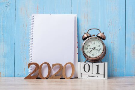 2020 Happy New Year  with blank notebook, retro alarm clock and wooden number. New Start, Resolution, Goals, Plan, Action and Mission Conceptの写真素材