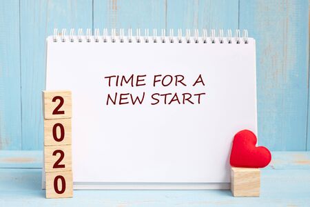 Time for A New Start words and 2020 cubes with red heart shape decoration on blue wooden table background. New Year NewYou, Goal, Resolution, health, Love and Happy Valentineâs day conceptの写真素材