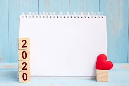 blank notebook and 2020 cubes with red heart shape decoration on blue wooden table background. New Year New You, Goal, Resolution, health, Love and Happy Valentineâs day conceptの写真素材