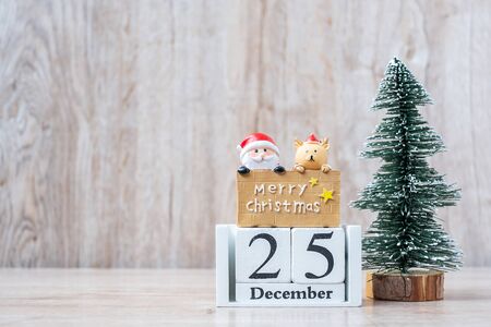 25 December calendar with Christmas decoration, snowman, Santa claus and pine tree  on wooden table background, preparation for holiday, Happy New Year and Xmas Conceptの写真素材