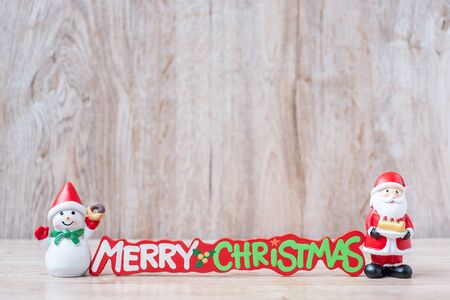 Christmas decoration, snowman, Santa claus and pine tree  on wooden table background, preparation for holiday, Happy New Year and Xmas Conceptの写真素材