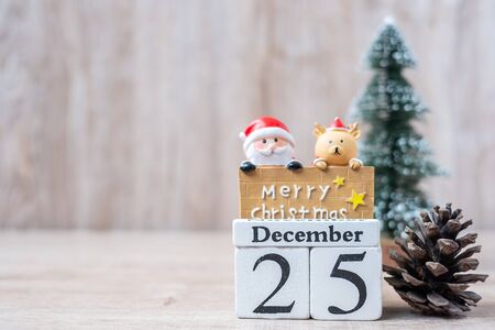 25 December calendar with Christmas decoration, snowman, Santa claus and pine tree  on wooden table background, preparation for holiday, Happy New Year and Xmas Conceptの写真素材